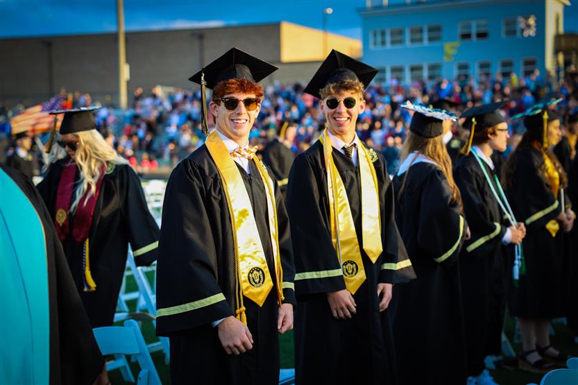 Students graduate on a football field
